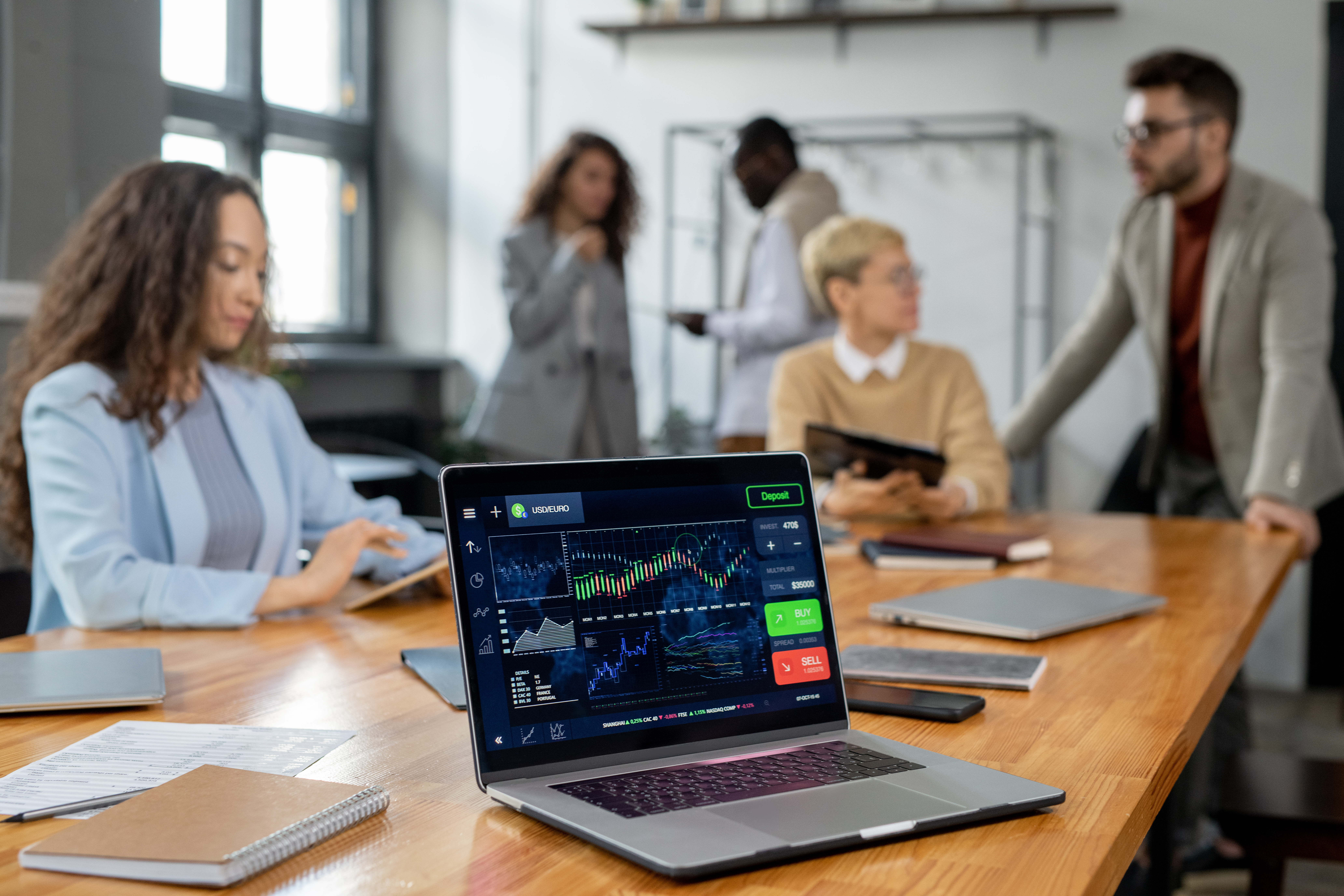 Laptop display with financial graph and other data