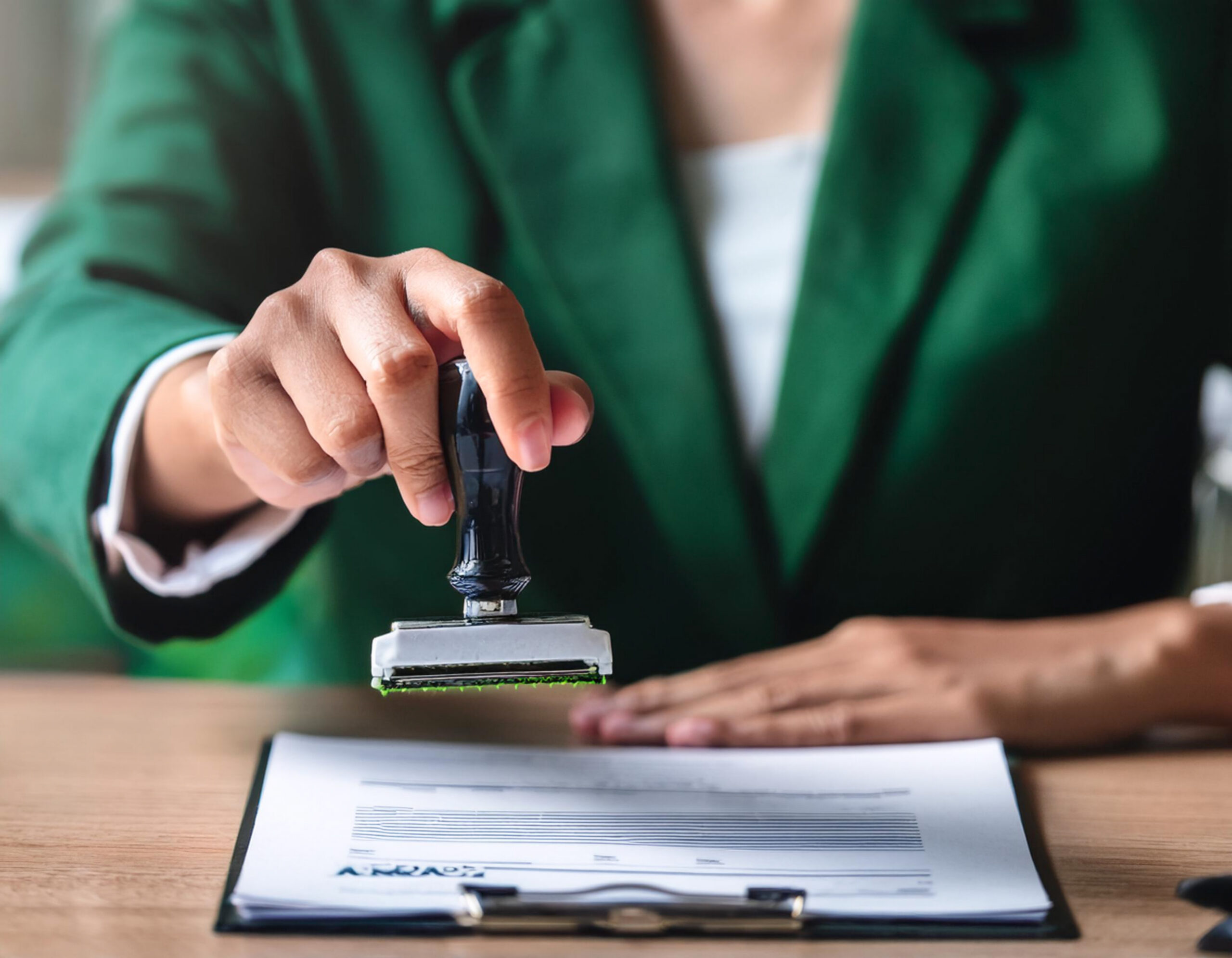 Business hand stamp approved on document for validates business documents agreements  in concept green business companies with eco-friendly waste management regulation