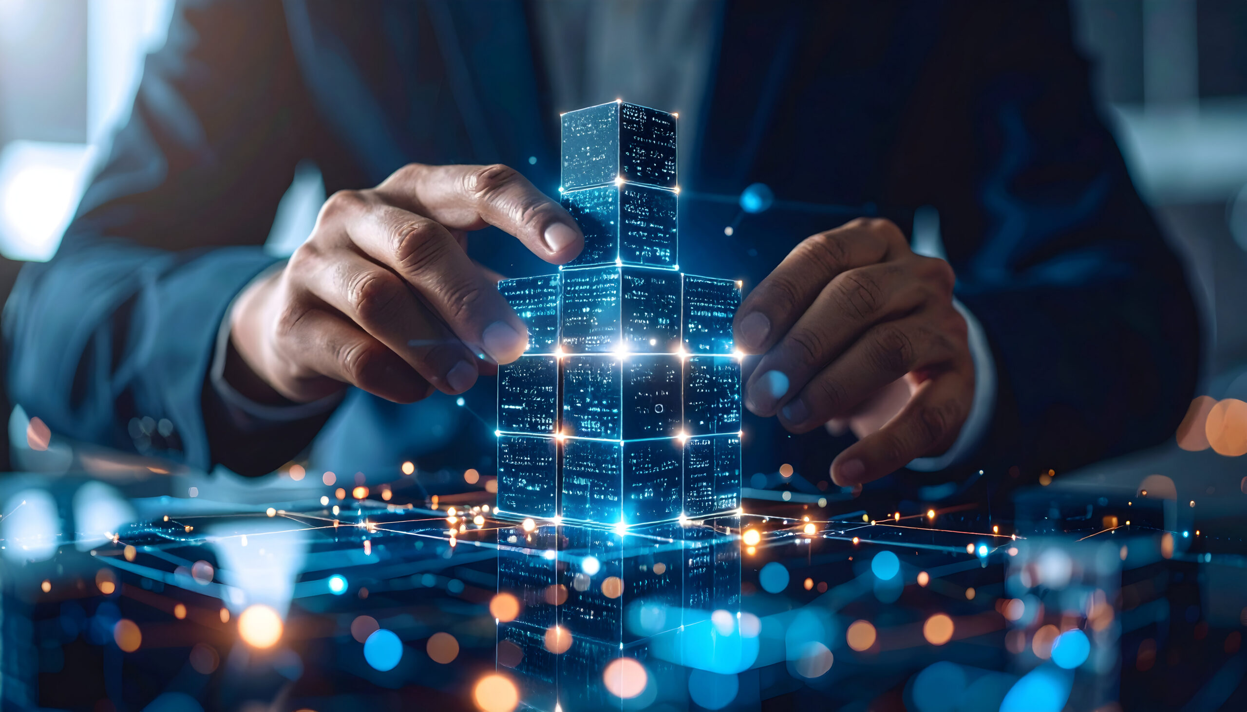 Human hands interact with glowing digital blocks, symbolizing data connection and future innovation